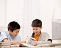 Student with text books helping friend do homework