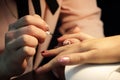 A student at the training courses of manicure prepares the hand of the client before applying shellac. application on