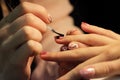 A student at the training courses of manicure prepares the hand of the client before applying shellac. application on