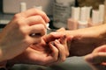 A student at the training courses of manicure prepares the hand of the client before applying shellac. applying a
