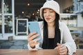 Student, travel and woman with phone at a cafe for social media, texting or chatting in a city. Smartphone, app and lady Royalty Free Stock Photo