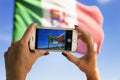 Student travels around Venice on a vaparetto and photographs the Italian flag on her smartphone. Travel concept.