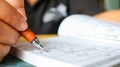 Student is trying to solve sudoku with color pencil as hobby a