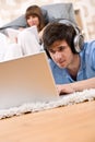 Student - Two teenager with laptop and headphones Royalty Free Stock Photo