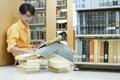 Student Of University Choosing Book and Reading Book In Library. Royalty Free Stock Photo