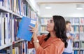 the student uses a notebook and a school library Royalty Free Stock Photo