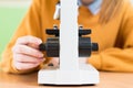 Student using microscope to examine samples in biology class. Royalty Free Stock Photo