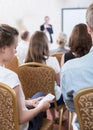 Student using phone during conference Royalty Free Stock Photo