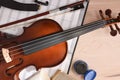 Student violin and folder with staves on wooden table top