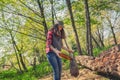 Student volunteer helps in cleaning the Park area. The girl puts a plastic bottle in a garbage bag Royalty Free Stock Photo