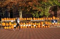 Student walking past carved Halloween pumpkin displays