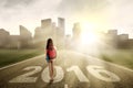Student walks on the road with numbers 2016
