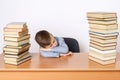 The student was tired of the lessons, fell asleep at the table. He has books on both sides