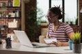 Student watching educational tutorial online on laptop, taking notes Royalty Free Stock Photo