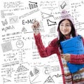 Student in winter clothes writes formula math Royalty Free Stock Photo