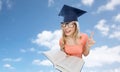 Student woman in mortarboard with encyclopedia Royalty Free Stock Photo