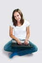 Student young girl with laptop computer on gray background