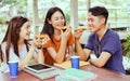 Students asian group together eating pizza in breaking time Royalty Free Stock Photo