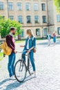 students with backpacks and bicycle standing on street with university Royalty Free Stock Photo