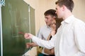 Students at a board solve a problem Royalty Free Stock Photo