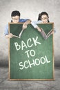 Students and books behind a chalkboard Royalty Free Stock Photo