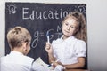 Students boy and girl at the Desk on the background of the slate Royalty Free Stock Photo