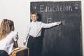 Students boy and girl at the Desk on the background of the slate Royalty Free Stock Photo