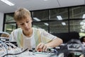 Students boy learning electrical appliances. education on table at class room, Robotics learning innovation.