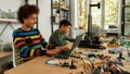 Pushing Limits. Students building and learning to program robot vehicle at a stem robotics class. Science and education. Royalty Free Stock Photo