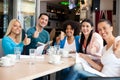 Students in cafe showing thumbs up