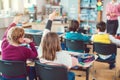 Students in class eager to answer a question to their teacher