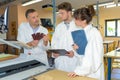 Students with clipboards with instructor