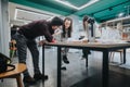 Students collaborate at a design studio table, reviewing architecture models and plans together Royalty Free Stock Photo