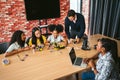 Students collaborate on robotics kits at a classroom table while a teacher guides them, using a laptop and tools during a hands-on Royalty Free Stock Photo