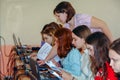 Students in a computer class with a teacher