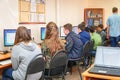 Students in a computer class with a teacher