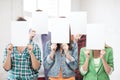 Students covering faces with blank papers Royalty Free Stock Photo