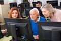 Students of different ages looking at monitor Royalty Free Stock Photo