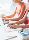 Students doing homeworks at desk Royalty Free Stock Photo