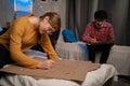 Students in a dorm room painting posters to protest to save the planet