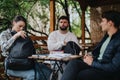 Students engaging in outdoor study session with backpacks and notebooks Royalty Free Stock Photo