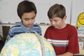 Students Examining A Globe Royalty Free Stock Photo