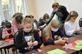 Students fold home-made origami from colored paper. Children`s master class during the coronavirus epidemic COVID-19 in Russia