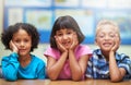 Students, friends and portrait or happiness in classroom for learning, knowledge or education at desk. Kids, face and Royalty Free Stock Photo