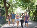 Students, friends and walking on campus with learning, knowledge and books or talking of college. Group of people with Royalty Free Stock Photo