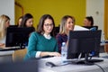 Students in front of computers at the informatics lecture. Smart young people study at the college. Education, college, university Royalty Free Stock Photo