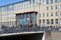students in front of the main entrance of cologne university