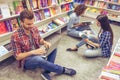 Students with gadget at the bookshop Royalty Free Stock Photo