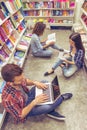 Students with gadget at the bookshop Royalty Free Stock Photo