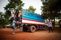 Students getting on a truck used as school bus